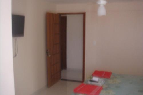 a room with a door and a red box on the floor at stellamares suites in Salvador