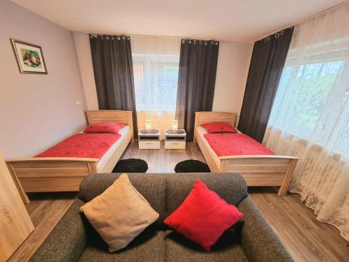 a living room with two beds and a couch at Workershome - Business Apartments - Monteurwohnungen in Wertheim
