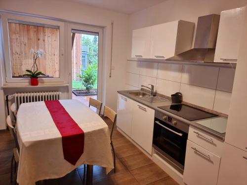 a kitchen with a table with a tablecloth on it at Workershome - Business Apartments - Monteurwohnungen in Wertheim