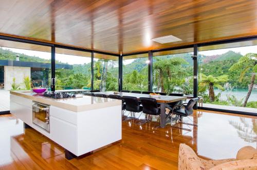 an open kitchen with a large group of windows at Waterfall Bay Glass House in Picton