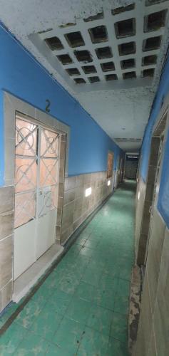 an empty hallway in a building with a blue wall at Departamentos muy cercanos al aeropuerto T2 wifi free in Mexico City