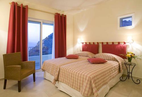 a bedroom with a bed and a large window at Villa Ares with private pool and a spectacular seaview 150m from the beach in Istron