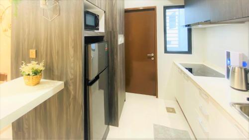 a kitchen with a stainless steel refrigerator in a kitchen at Floral Elegance2 @ Galacity in Kuching