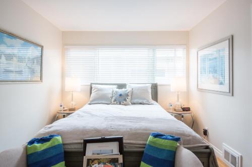 a bedroom with a large bed with two lamps at Overlooking Marina del Rey sailboats, is Green Ginger Playa Del Rey on the bluff, in Los Angeles