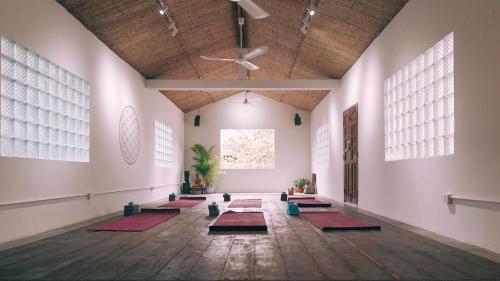 a room with a row of yoga mats on the floor at Monkey Republic Kampot in Kampot