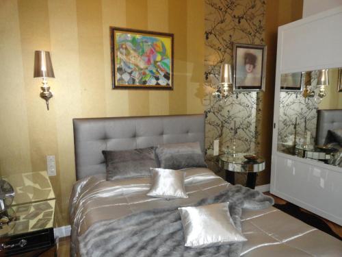 a bedroom with a large bed with pillows on it at Boudoir Budapest Apartment in Budapest