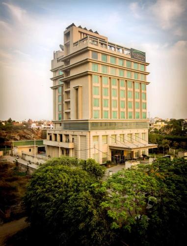 a large building with a sign on top of it at Goldfinch Hotel Delhi NCR in Faridabad