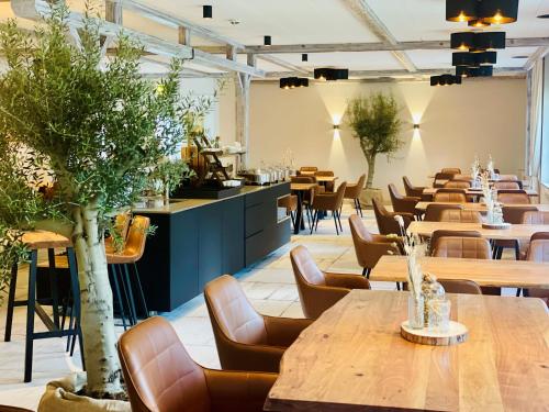 a row of tables and chairs in a restaurant at Spree - Waldhotel Cottbus in Cottbus