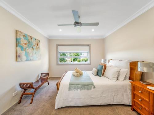 a bedroom with a large bed and a window at Gather at Vincentia in Vincentia