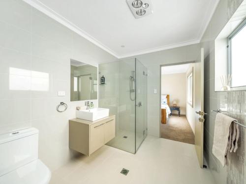 a bathroom with a toilet sink and a shower at Gather at Vincentia in Vincentia