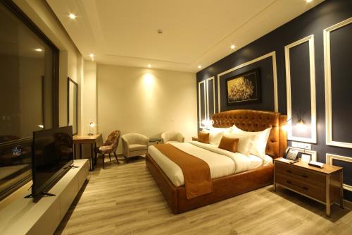 a hotel room with a bed and a television at Best Western Premier Hotel Gulberg Lahore in Lahore