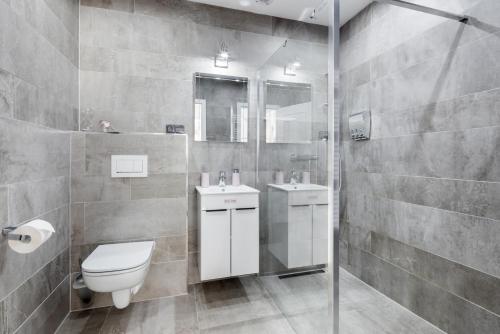 a bathroom with a toilet and a sink and a shower at Penzion Belle Donne in Znojmo