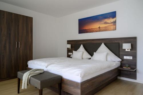 a bedroom with a large bed with white sheets at Kurviertel Wohnung III in Überlingen