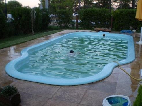 a pool with a person swimming in it at Pinares de Colon in Colón