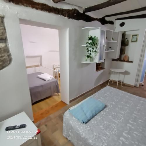 a small room with two beds and a table at Casa nella roccia in Bomarzo
