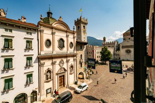 a city street filled with lots of buildings and cars at Boutique Exclusive B&B in Trento