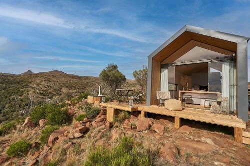 a house on a hill with a view of the mountains at Mount Camdeboo Private Game Reserve by NEWMARK in Graaff-Reinet