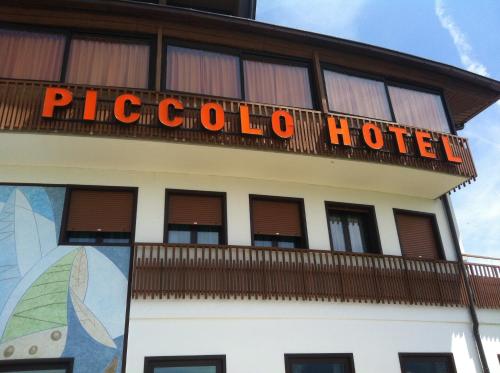 a hotel with a sign on top of it at Piccolo Hotel Sciliar in Alpe di Siusi