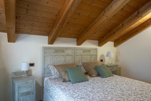 a bedroom with a large bed and wooden ceilings at Ca di Nadia in Aosta