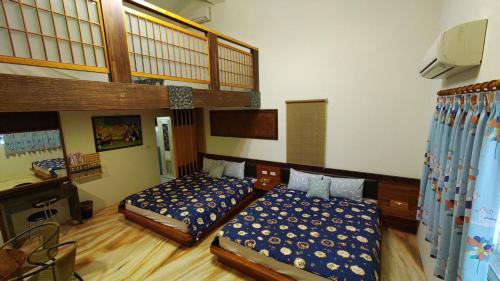 Postel nebo postele na pokoji v ubytování 鄉間雅築休閒民宿Country Villa Homestay