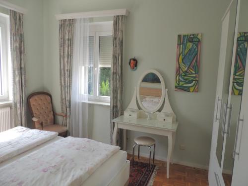 sypialnia z łóżkiem, toaletką i lustrem w obiekcie Appartement " Am Fasangarten " w Wiedniu