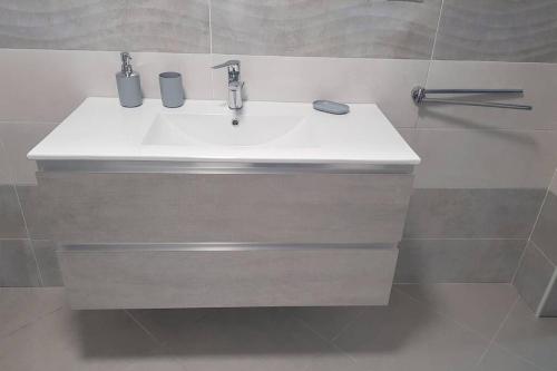 a bathroom sink with two cups on top of it at LA PERLA DEL BAROCCO - NOTO in Noto