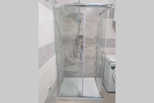 a shower with a glass door in a bathroom at LA PERLA DEL BAROCCO - NOTO in Noto