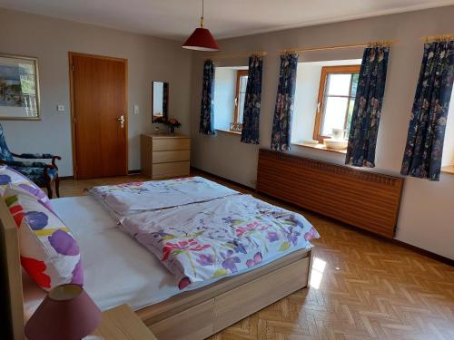 a bedroom with a large bed in a room at Ferienwohnung Setzer Mühle in Saint-Vith