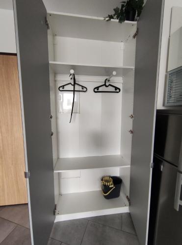 a walk in pantry with two hangers at Apartament FILO in Pogórze