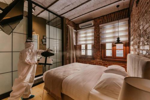 a man standing next to a bed in a room at Galadoo Suites 3rd Floor in Istanbul