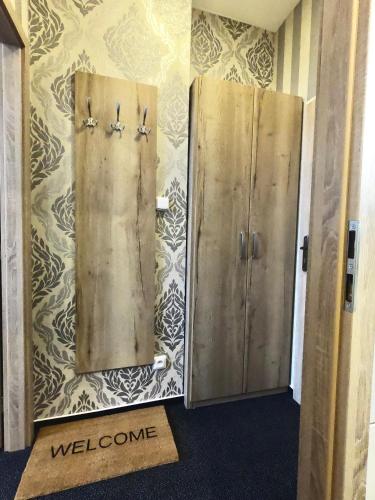 two metal doors on a wall with a welcome sign at Restaurace Stará Lípa in Česká Lípa