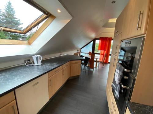 a kitchen with a counter top and a window at Elegantes Apartment in Wendelstein