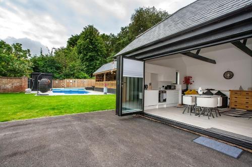 a kitchen and living area of a house with a patio at Luxury retreat 32c pool jacuzzi games bar oasis in Deal