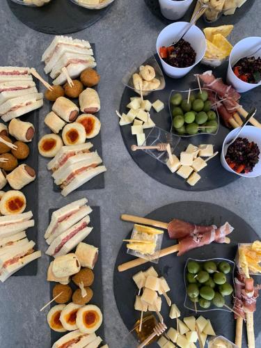 a table topped with plates of sandwiches and other appetizers at Gioema in Borgo Vodice