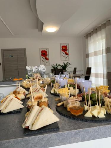 a buffet with sandwiches and other foods on a table at Gioema in Borgo Vodice