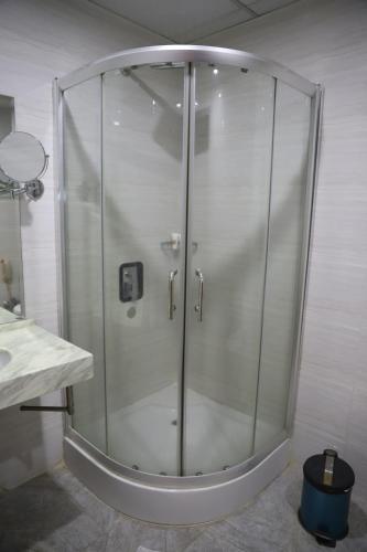 a shower with a glass door in a bathroom at Gloria Aqua Park Hotel in Aswan