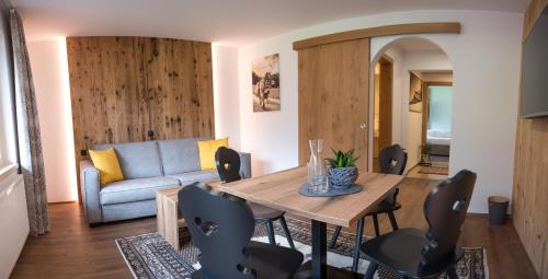 a living room with a wooden table and chairs at Sonnenhang Montafon in Sankt Gallenkirch