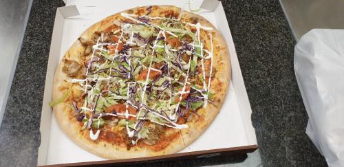 a pizza in a box on a table at Haiminger Hof in Haiming