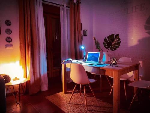 a room with a table with a laptop computer on it at Las Casitas de Santillana in Santillana del Mar