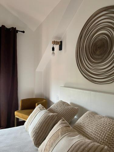 a bedroom with a bed and a sculpture on the wall at Las Casitas de Santillana in Santillana del Mar