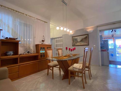a kitchen and dining room with a table and chairs at Siga Siga Apartment in Megara