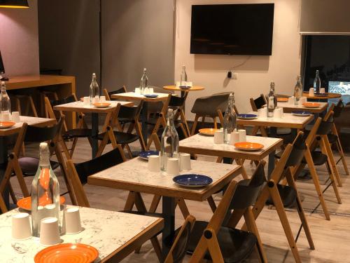 a room with tables and chairs and a projection screen at Holiday Inn Express Hyderabad Banjara Hills by IHG in Hyderabad
