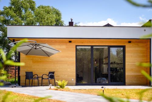 a house with a patio and an umbrella at Вудхарт2 in Yasinya