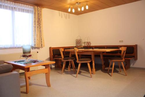 a living room with a dining room table and chairs at Bergjuwel in Schruns
