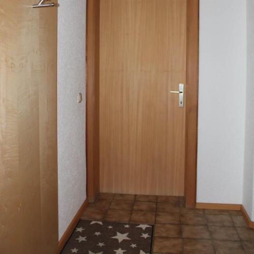 a hallway with a door and a rug on the floor at Bergjuwel in Schruns-Tschagguns