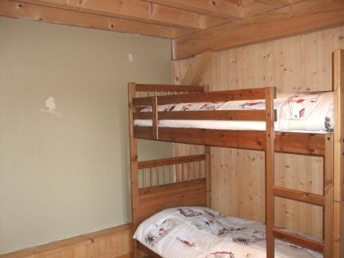 two bunk beds in a room with wooden walls at Chalet montagne 11 p Grand Massif 100 m télécabine in Morillon