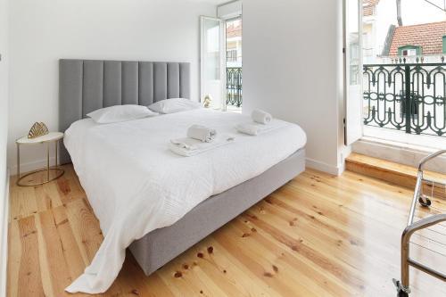 a bedroom with a large bed with two towels on it at Cosy Room in Alcantara - Lisboa in Lisbon
