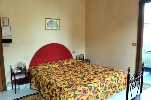 a bedroom with a bed with a colorful bedspread at Hotel Italia in Turin