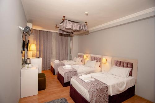 מיטה או מיטות בחדר ב-SRF Hotel