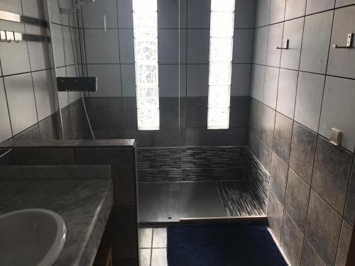 a bathroom with a shower with a sink and a tub at Villa Maria in Playa Blanca